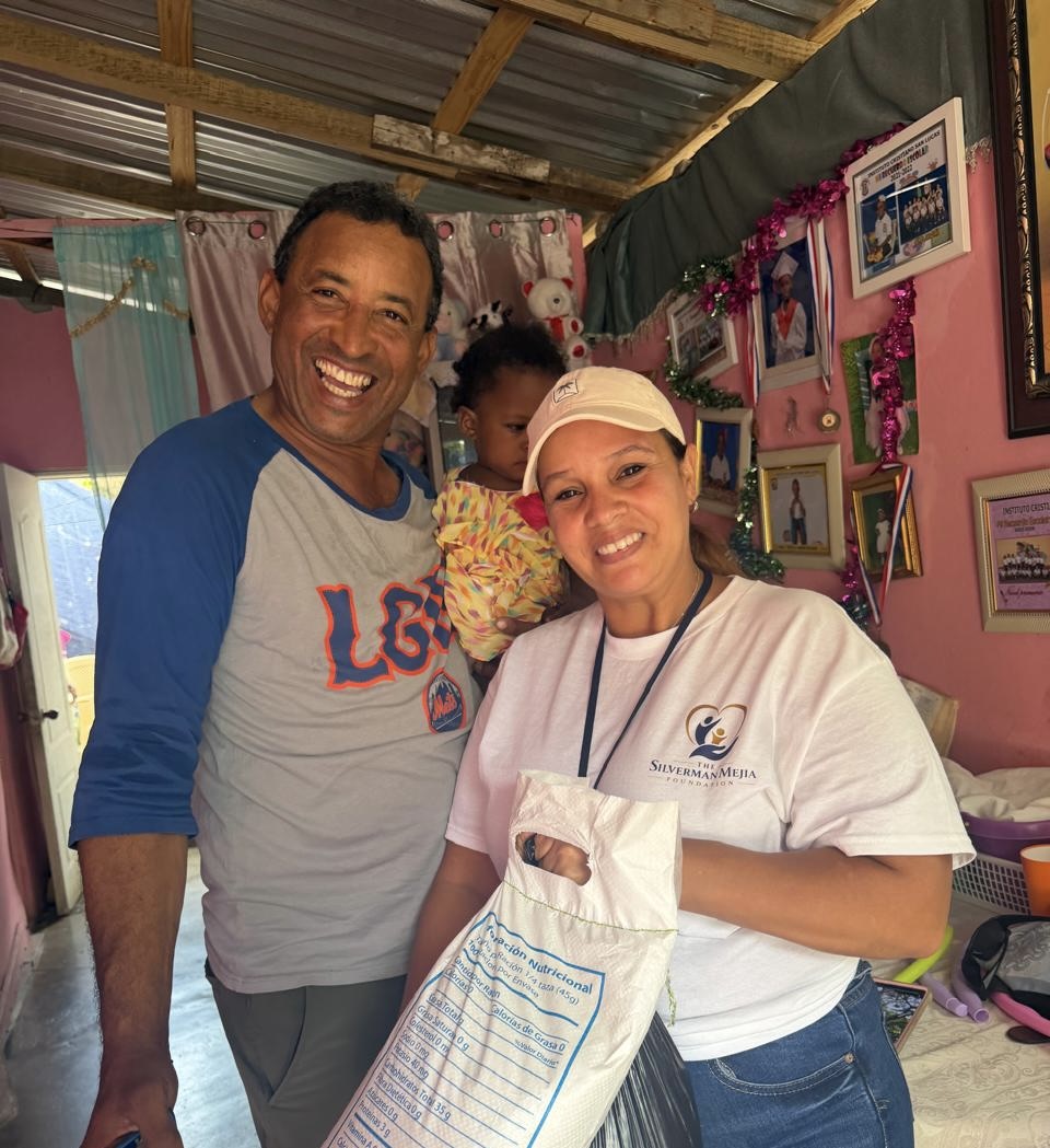 Foundation volunteers providing food support to a family