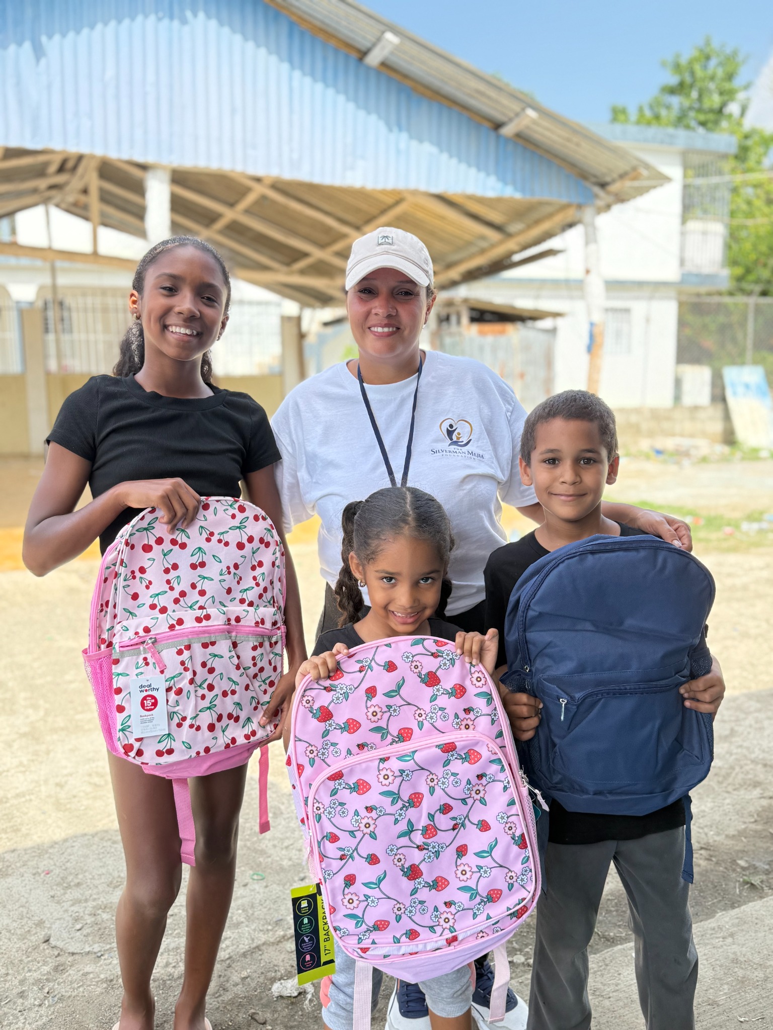 Children and volunteers with backpacks