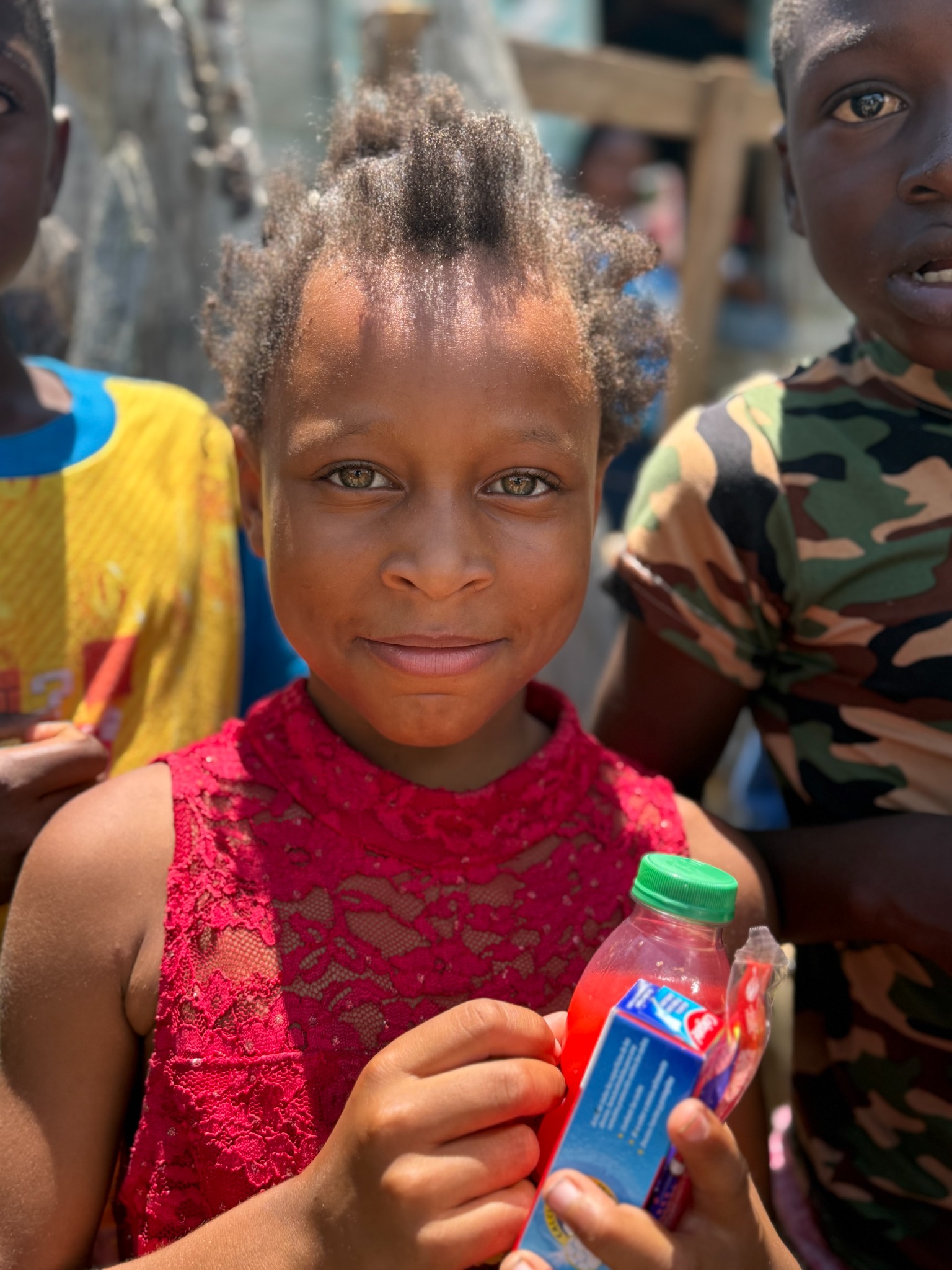 Child holding a drink at a community event